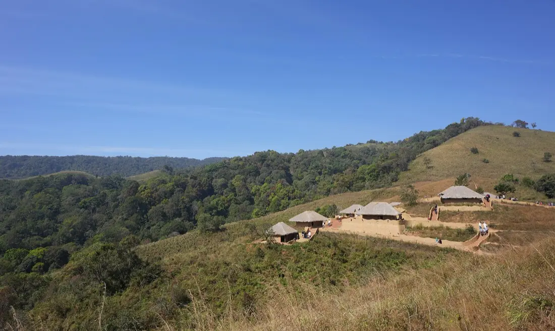 Thatched huts on a hillside at En Ooru tribal heritage village, Pookode, Wayanad