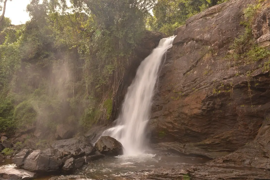 Water dropping over dark rock at Soochipara Falls, Wayanad