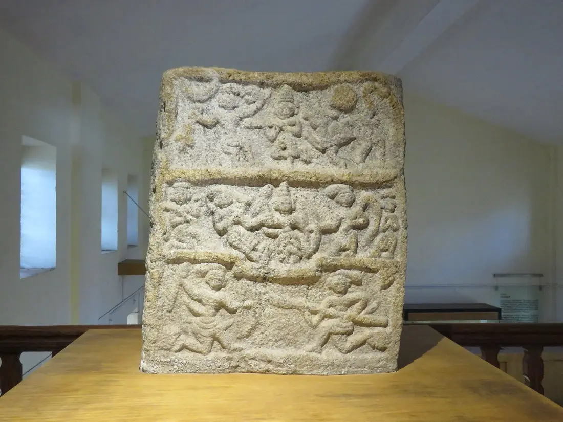 A carved stone hero-slab on display at the Wayanad Heritage Museum, Ambalavayal